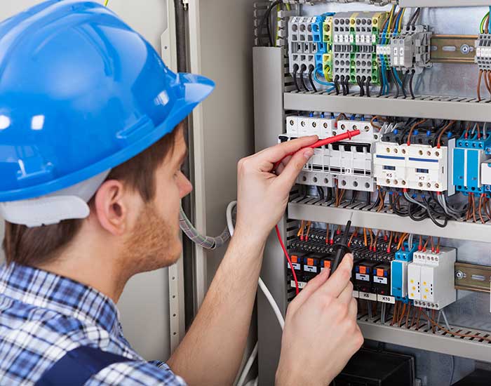 Electrician examining fusebox